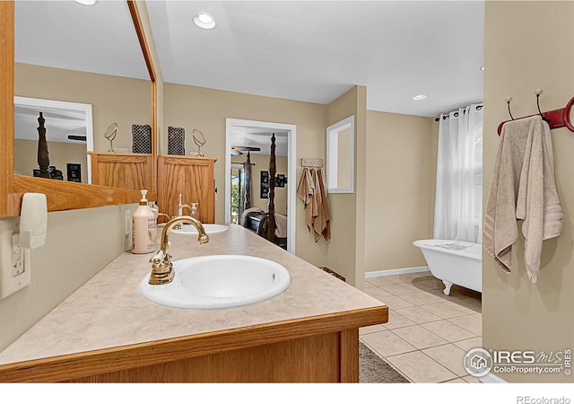 1470 71st Ave, Greeley, CO 80634 - bathroom with a freestanding tub, vanity, tile patterned floors, plenty of natural light, and recessed lighting