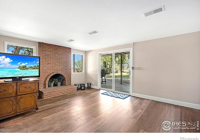1470 71st Ave, Greeley, CO 80634 - unfurnished living room featuring wood finished floors and a fireplace