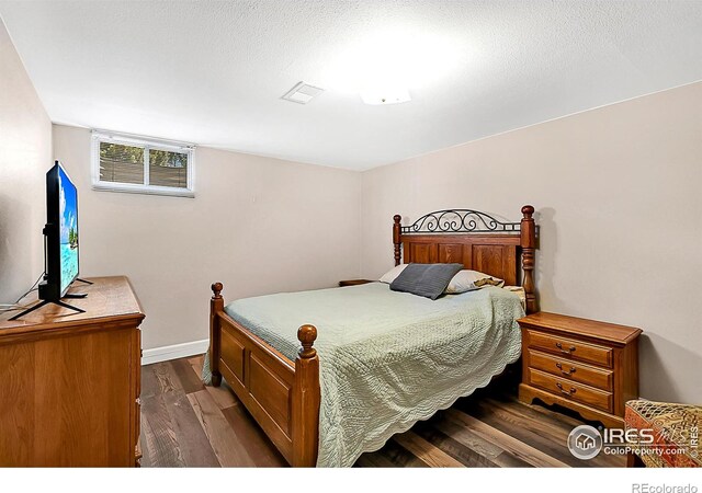 1470 71st Ave, Greeley, CO 80634 - bedroom featuring dark wood finished floors and baseboards