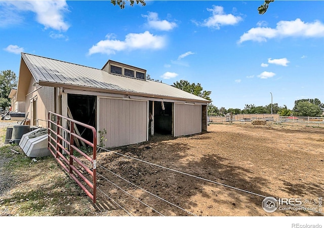 1470 71st Ave, Greeley, CO 80634 - back of property featuring a metal roof, an exterior structure, and an outbuilding
