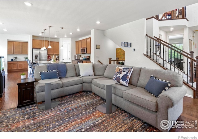 833 Carbonate Ln, Erie, CO 80516 - living room with recessed lighting, wood finished floors, and stairs