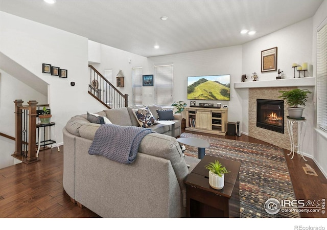 833 Carbonate Ln, Erie, CO 80516 - living room with wood finished floors, recessed lighting, a tile fireplace, and stairs