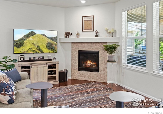 833 Carbonate Ln, Erie, CO 80516 - living area with a tile fireplace, dark wood-style floors, and recessed lighting