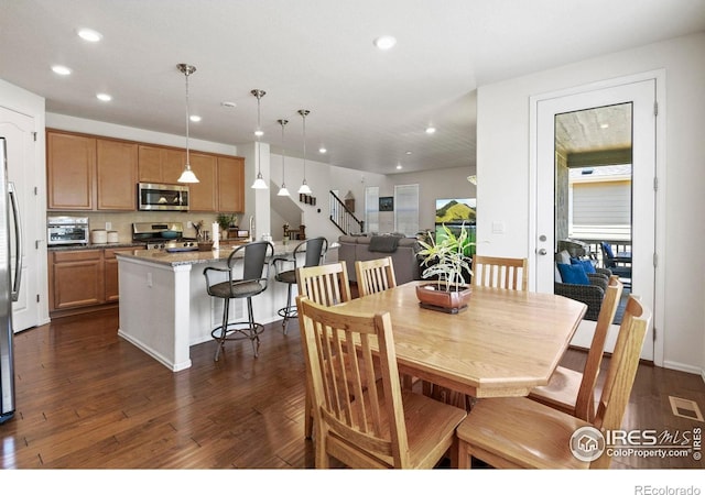 833 Carbonate Ln, Erie, CO 80516 - dining space with recessed lighting, dark wood-style floors, and stairs