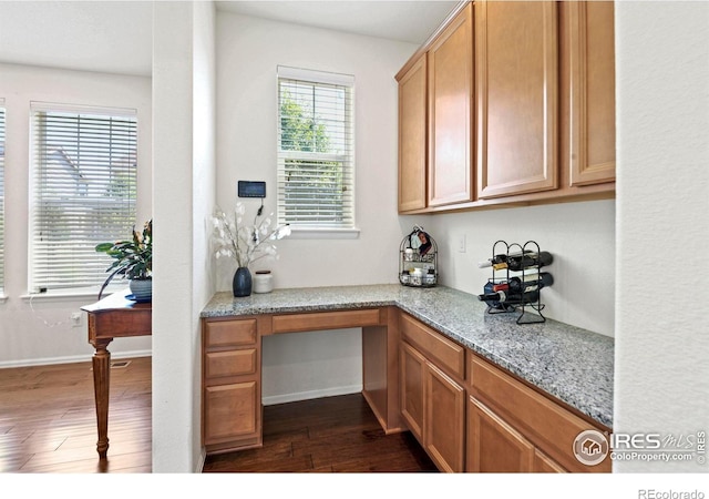 833 Carbonate Ln, Erie, CO 80516 - office area featuring dark wood-type flooring and built in study area