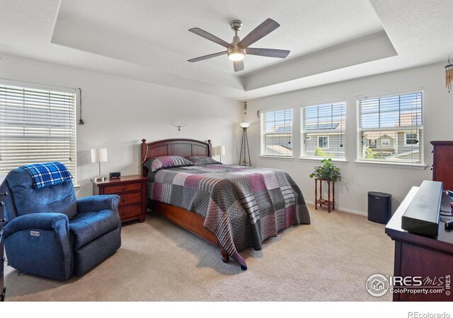 833 Carbonate Ln, Erie, CO 80516 - carpeted bedroom with a raised ceiling and ceiling fan