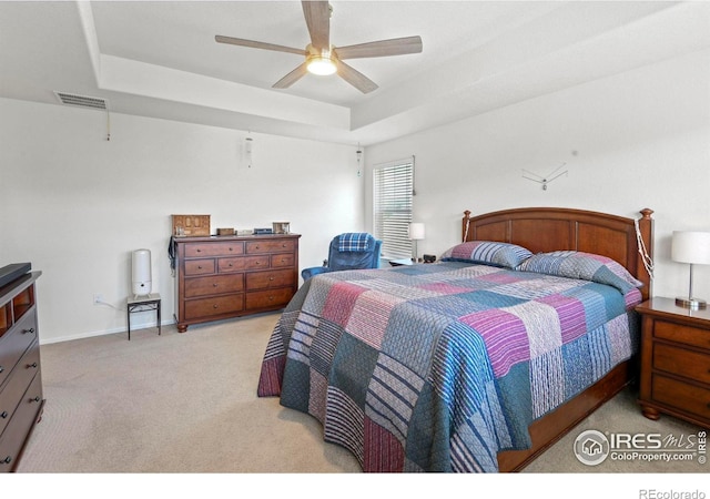 833 Carbonate Ln, Erie, CO 80516 - bedroom featuring a tray ceiling, light colored carpet, and ceiling fan