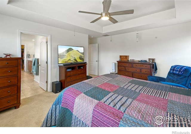 833 Carbonate Ln, Erie, CO 80516 - bedroom with a raised ceiling, light colored carpet, ceiling fan, and ensuite bath