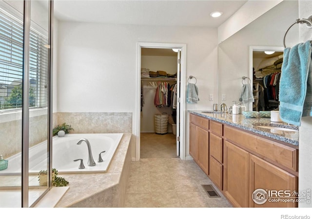 833 Carbonate Ln, Erie, CO 80516 - bathroom with a garden tub, double vanity, and a spacious closet