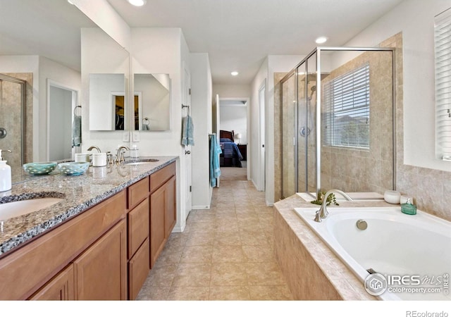 833 Carbonate Ln, Erie, CO 80516 - full bathroom with a garden tub, a stall shower, double vanity, tile patterned floors, and recessed lighting