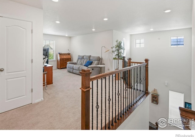 833 Carbonate Ln, Erie, CO 80516 - hallway with an upstairs landing, carpet floors, recessed lighting, and healthy amount of natural light