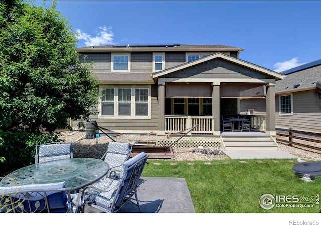833 Carbonate Ln, Erie, CO 80516 - back of house with outdoor dining space, solar panels, a deck, a lawn, and a patio area
