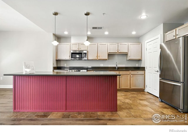 1631 N Emerson St Unit 207, Denver, CO 80218 - kitchen with appliances with stainless steel finishes, dark countertops, decorative light fixtures, recessed lighting, and a breakfast bar area