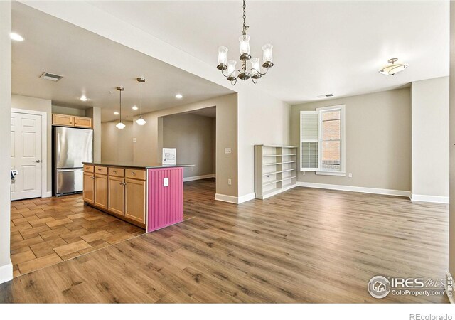1631 N Emerson St Unit 207, Denver, CO 80218 - kitchen featuring freestanding refrigerator, dark countertops, light wood-style flooring, a chandelier, and recessed lighting
