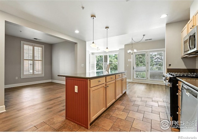 1631 N Emerson St Unit 207, Denver, CO 80218 - kitchen featuring stainless steel appliances, dark countertops, a chandelier, a center island, and recessed lighting