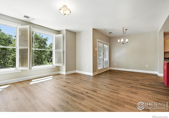 1631 N Emerson St Unit 207, Denver, CO 80218 - unfurnished room featuring a chandelier and wood finished floors