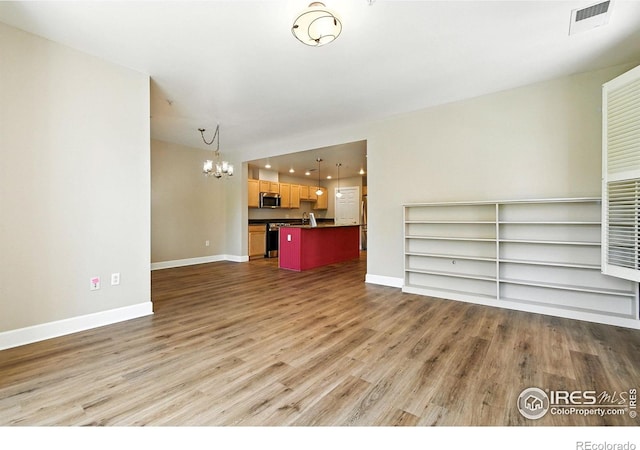 1631 N Emerson St Unit 207, Denver, CO 80218 - unfurnished living room featuring a chandelier and wood finished floors