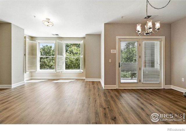 1631 N Emerson St Unit 207, Denver, CO 80218 - unfurnished dining area featuring wood finished floors and a chandelier