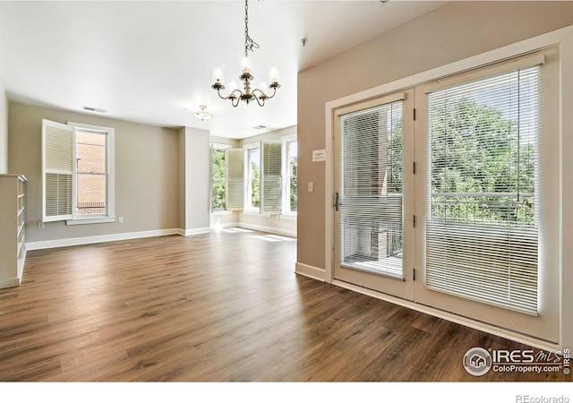1631 N Emerson St Unit 207, Denver, CO 80218 - unfurnished dining area featuring a chandelier and wood finished floors