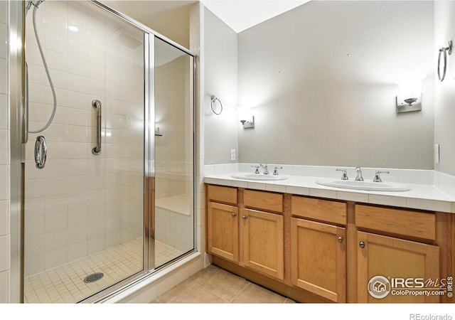 1631 N Emerson St Unit 207, Denver, CO 80218 - bathroom featuring a stall shower, tile patterned flooring, and double vanity
