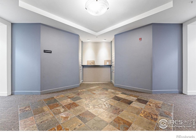 1631 N Emerson St Unit 207, Denver, CO 80218 - spare room with stone tile flooring, a raised ceiling, and a pendent fire sprinkler