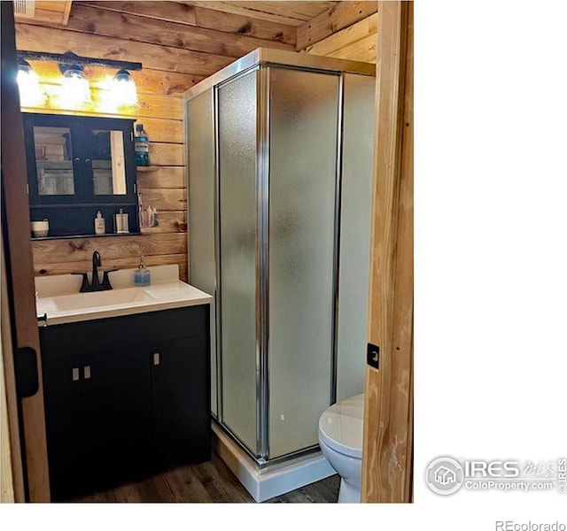 2780 Camel Rock Rd, Red Feather Lakes, CO 80545 - full bath with wood walls, vanity, wood finished floors, and a shower stall