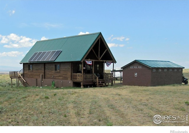2780 Camel Rock Rd, Red Feather Lakes, CO 80545 - view of front of property featuring a porch, a metal roof, and solar panels