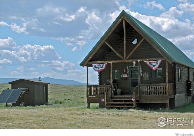 2780 Camel Rock Rd, Red Feather Lakes, CO 80545 - view of front of property featuring a porch, a mountain view, and log exterior