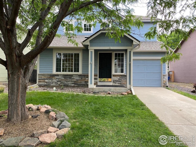 6126 Shamrock Cir, Frederick, CO 80530 - view of front of property with stone siding, a front yard, driveway, and a shingled roof