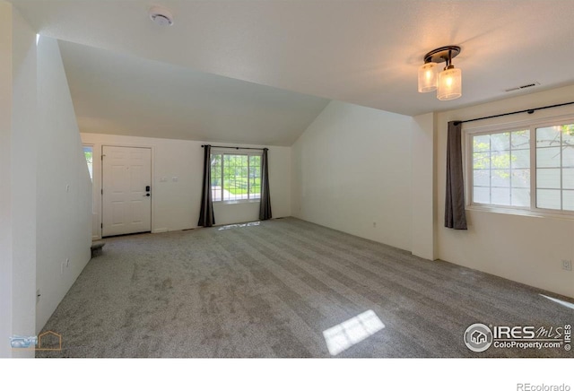 6126 Shamrock Cir, Frederick, CO 80530 - unfurnished living room with carpet and lofted ceiling