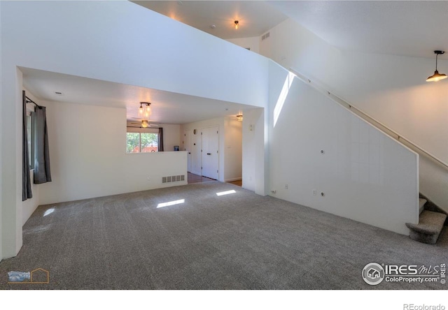 6126 Shamrock Cir, Frederick, CO 80530 - unfurnished living room with carpet flooring, stairs, and a high ceiling