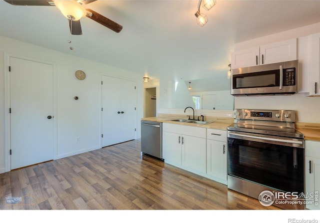 6126 Shamrock Cir, Frederick, CO 80530 - kitchen featuring stainless steel appliances, light wood-style flooring, and white cabinets