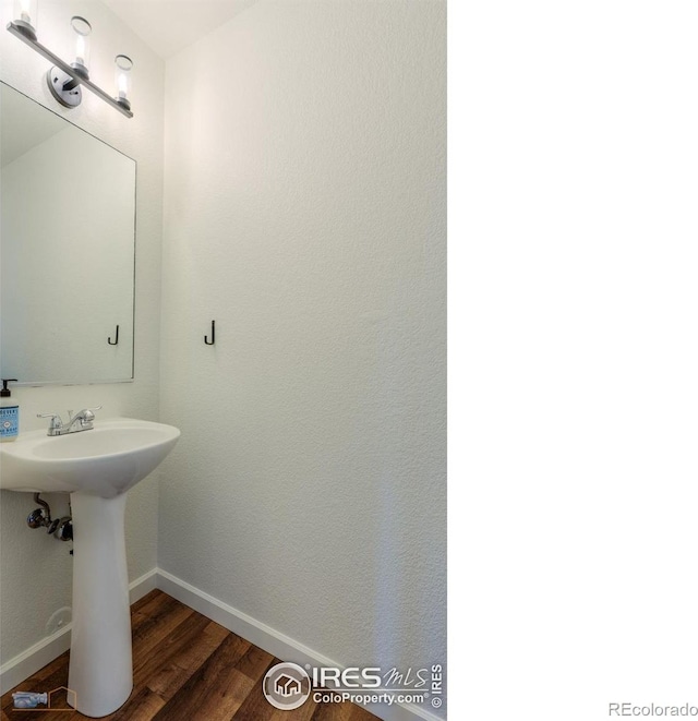 6126 Shamrock Cir, Frederick, CO 80530 - bathroom featuring baseboards and wood finished floors