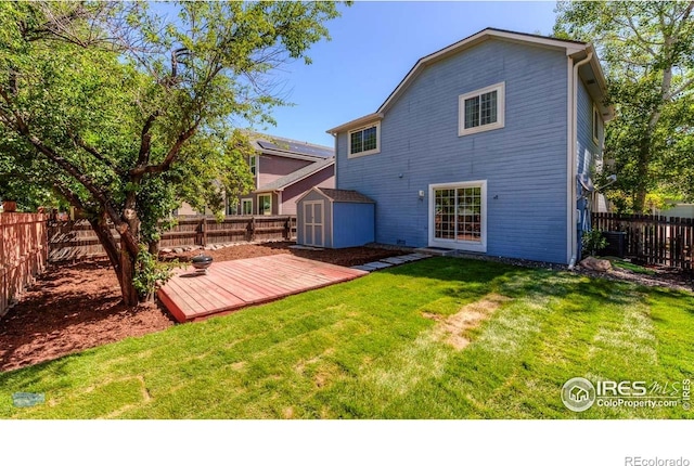 6126 Shamrock Cir, Frederick, CO 80530 - rear view of house featuring a fenced backyard, a deck, and a storage unit