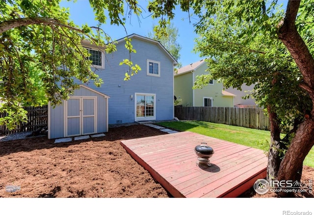 6126 Shamrock Cir, Frederick, CO 80530 - back of property with a fenced backyard, a deck, and a storage shed