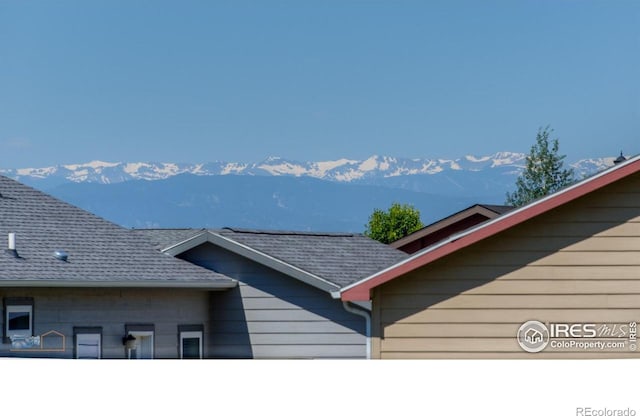 6126 Shamrock Cir, Frederick, CO 80530 - exterior view of a mountainous background, a shingled roof, and a downspout