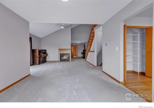 147 Keystone Trl, Broomfield, CO 80020 - unfurnished living room featuring stairs, carpet flooring, and a tiled fireplace