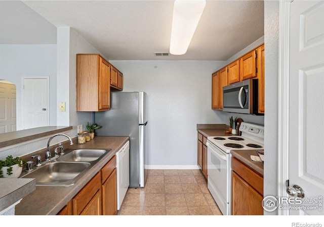5620 Fossil Creek Pkwy Unit 6303, Fort Collins, CO 80525 - kitchen with white appliances and brown cabinetry