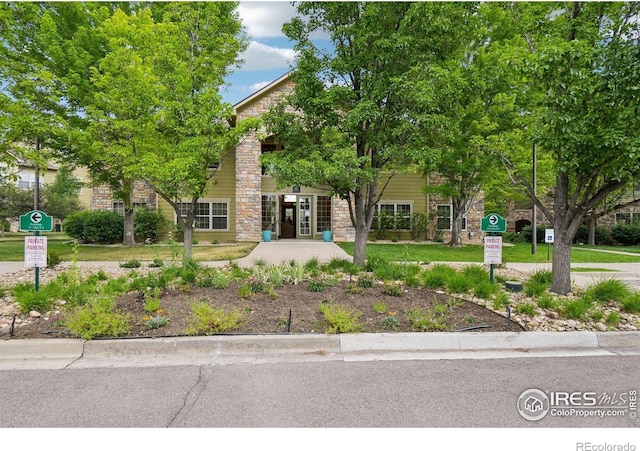 5620 Fossil Creek Pkwy Unit 6303, Fort Collins, CO 80525 - view of property hidden behind natural elements with french doors and stone siding