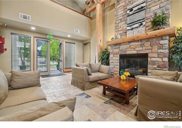5620 Fossil Creek Pkwy Unit 6303, Fort Collins, CO 80525 - living room with stone tile floors, a stone fireplace, and high vaulted ceiling