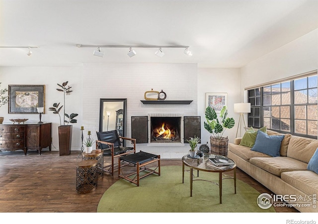 7250 Eastmoor Dr, Denver, CO 80237 - living room featuring wood finished floors, rail lighting, and a brick fireplace