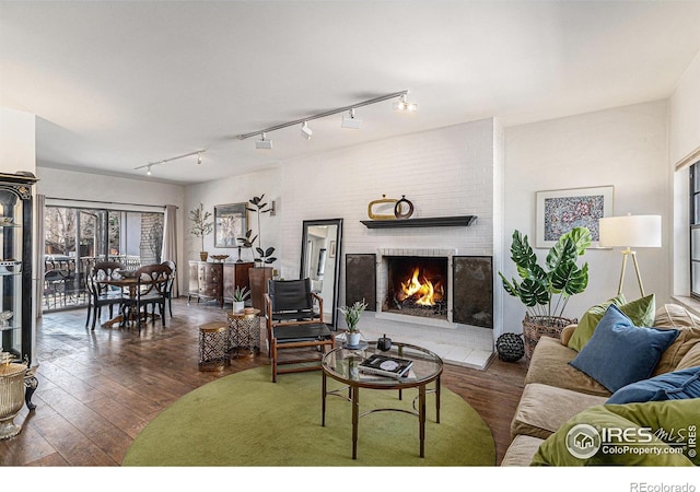 7250 Eastmoor Dr, Denver, CO 80237 - living area featuring hardwood / wood-style floors, rail lighting, and a brick fireplace