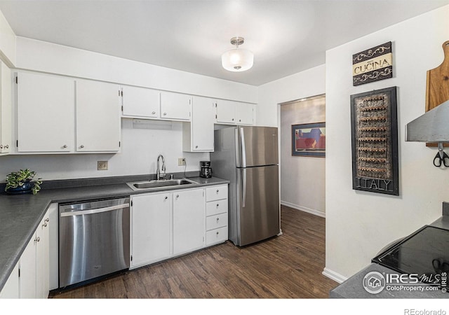7250 Eastmoor Dr, Denver, CO 80237 - kitchen with stainless steel appliances, dark countertops, dark wood-style flooring, and white cabinets