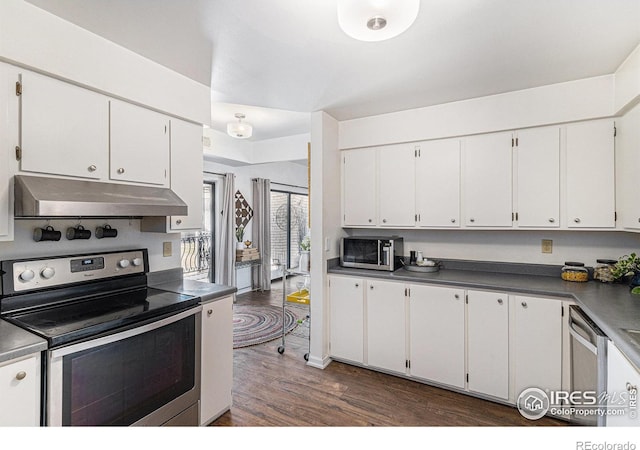 7250 Eastmoor Dr, Denver, CO 80237 - kitchen featuring appliances with stainless steel finishes, under cabinet range hood, dark wood-style floors, and white cabinetry