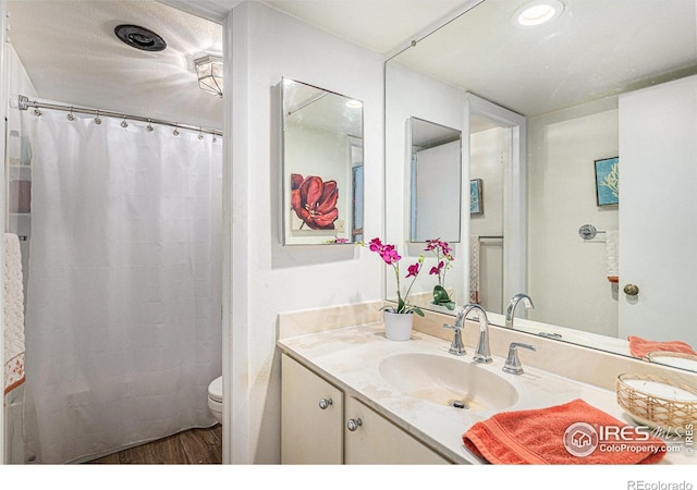 7250 Eastmoor Dr, Denver, CO 80237 - full bath with vanity and wood finished floors