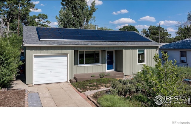 7850 Raleigh Pl, Westminster, CO 80030 - ranch-style house featuring a shingled roof, concrete driveway, solar panels, and an attached garage