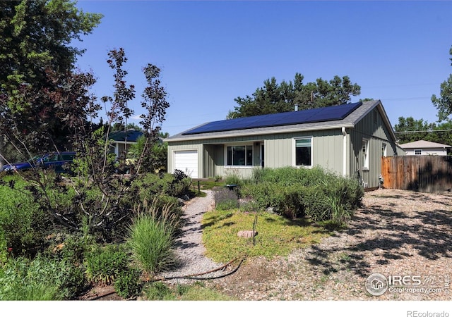 7850 Raleigh Pl, Westminster, CO 80030 - view of front of house featuring a garage and roof mounted solar panels