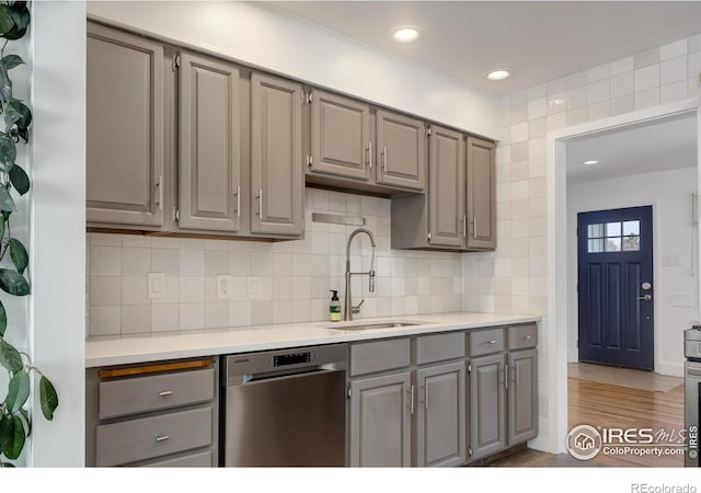 7850 Raleigh Pl, Westminster, CO 80030 - kitchen featuring gray cabinetry, dishwasher, light countertops, backsplash, and light wood-type flooring