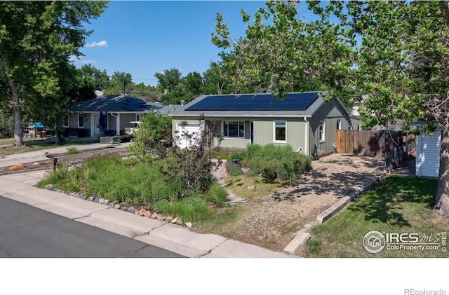 7850 Raleigh Pl, Westminster, CO 80030 - ranch-style house with roof mounted solar panels and a garage