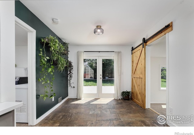 7850 Raleigh Pl, Westminster, CO 80030 - foyer featuring french doors, dark stone finish flooring, and a barn door